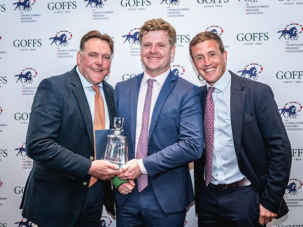 Dave Futter (left) and Will Kinsey of Peel Bloodstock (right), breeders of the Grade 1 performer High Class Hero, receiving the Mickley Stud Trophy from Finn Kent